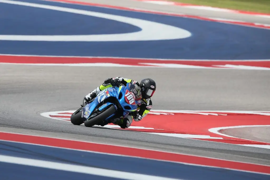 Performance suspension components laid out in a race paddock next to a King of the Baggers bagger