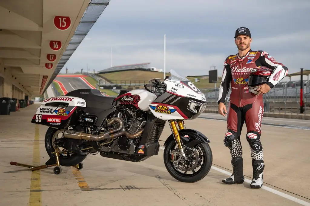A performance touring bike strapped to a dyno during a tuning session, rear wheel spinning